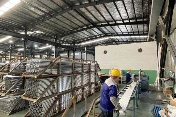 Aluminum Extrusion Process Press Pushing Heated Billet Through Extrusion Die at Xingyong aluminum pole factory