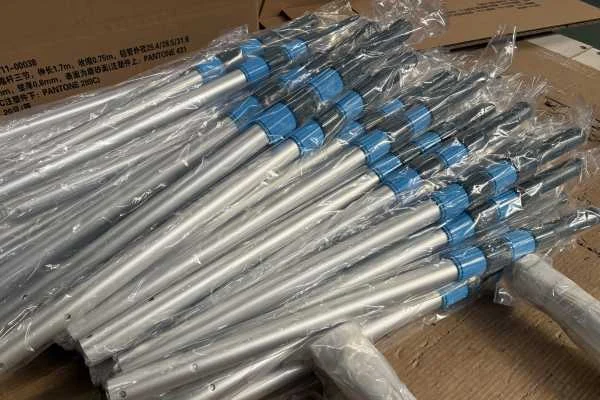 Close-up of an anodized aluminum pool pole tube, telescopic lock, and grip