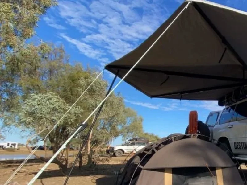 Patio awning support pole bracing a retractable
