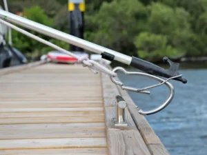 Telescoping aluminum boat hook reaching a dock piling