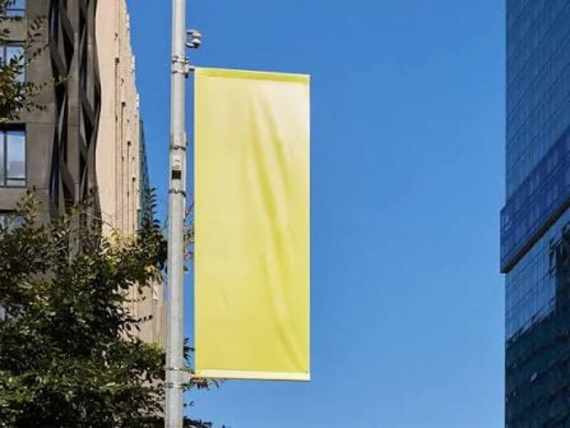Horizontal banner stretched between two aluminum poles