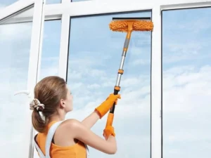 Painter rolling a ceiling with roller on an aluminum extension pole
