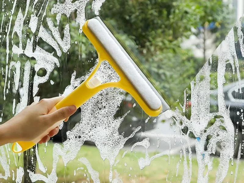 Professional window cleaner using route-grade aluminum pole equipment