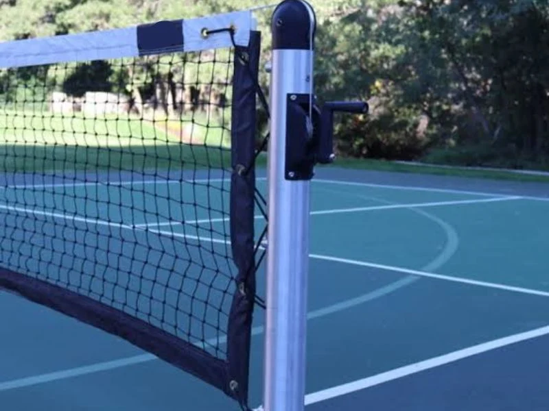 Removable pickleball post lifting from a ground sleeve