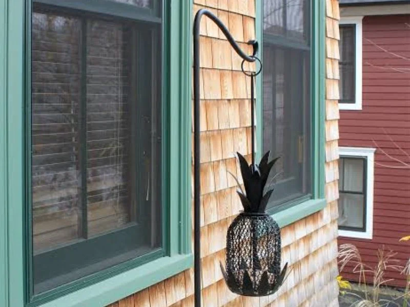 Aluminum shepherds hook bird feeder pole in a garden