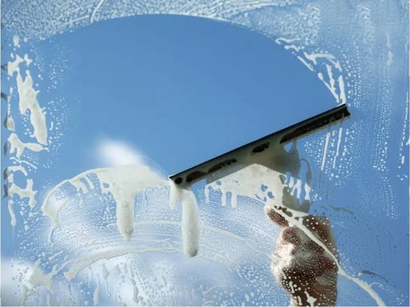 Squeegee head mounted on an aluminum handle, close up