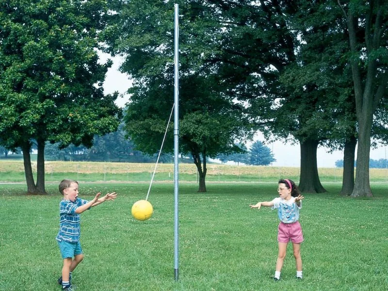 Kids playing on a height-adjusted tetherball pole