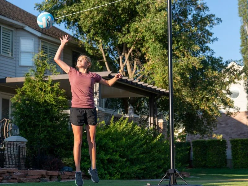 Portable base tetherball pole on a driveway
