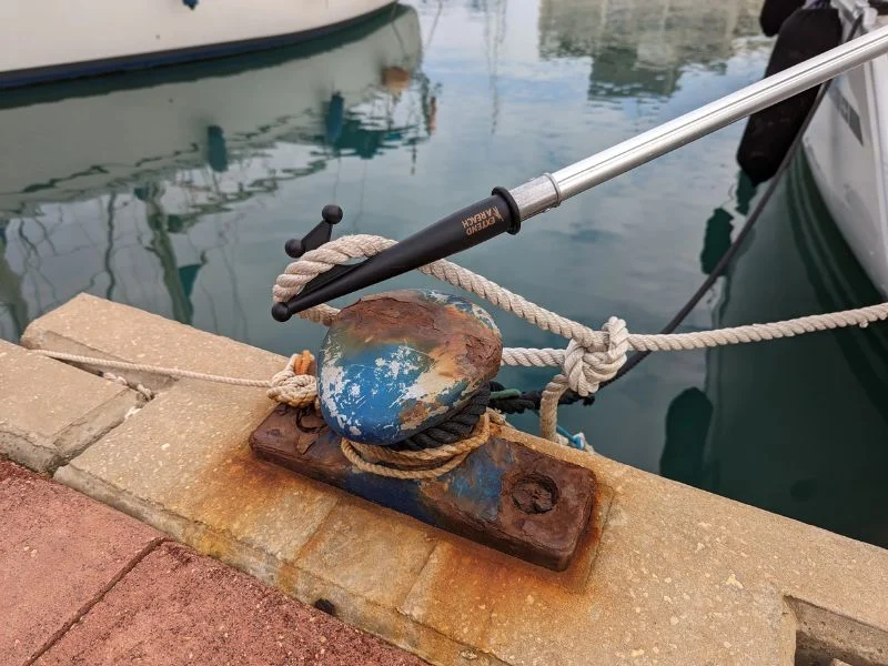 Boat hook loaded sideways against a piling