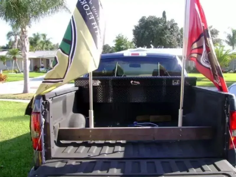 Molded truck flag mount bodies for stake pockets and bed rails